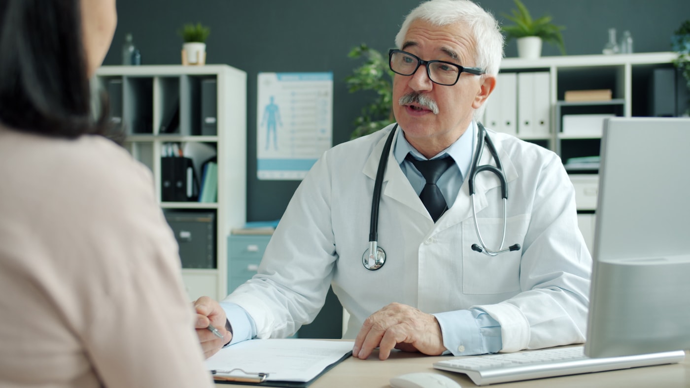 A doctor discussing treatment options with a patient in a consultation room
